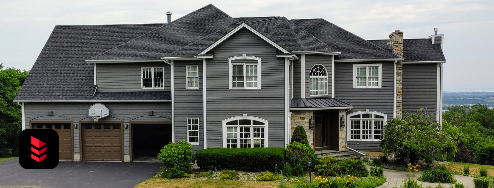 Large gray Vermont home with new architectural shingle roofing installed by RoofPros.Plus